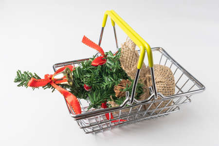 Christmas tree in a supermarket basket on a white backgroundの写真素材