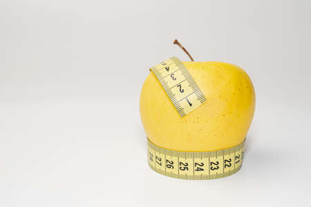 yellow apple diet ribbon on a white backgroundの写真素材
