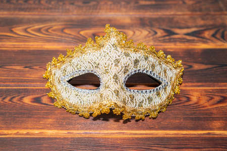 carnival golden mask on a wooden backgroundの写真素材