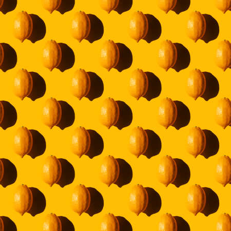 seamless lemon pattern with a hard shadow on a yellow backgroundの写真素材