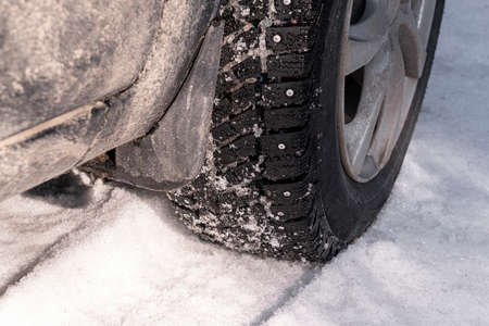 a car wheel with spikes in the snowの写真素材