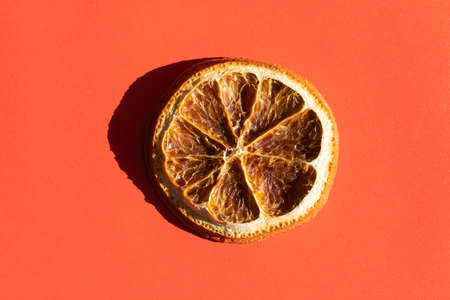 a slice of dried orange with a hard shadeの写真素材