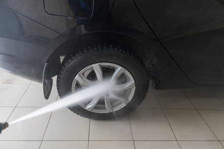 Washing the car with high-pressure detergent. Selective focusing shot