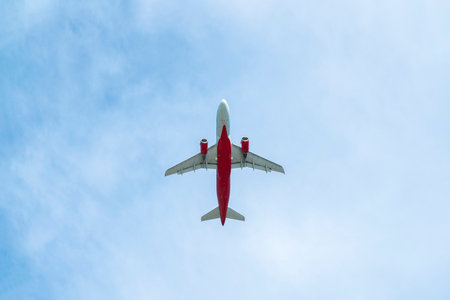 the plane is flying against the blue skyの写真素材