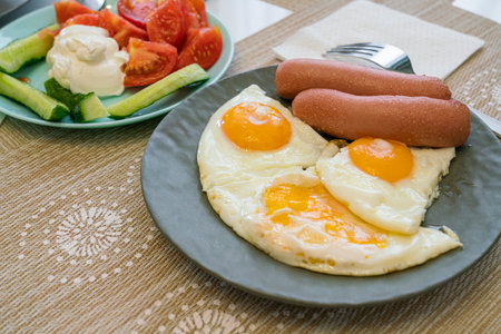 morning breakfast of scrambled eggs with sausage and salad. photoの写真素材