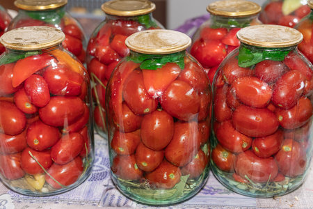 Canned tomatoes in glass jars on the tableの写真素材