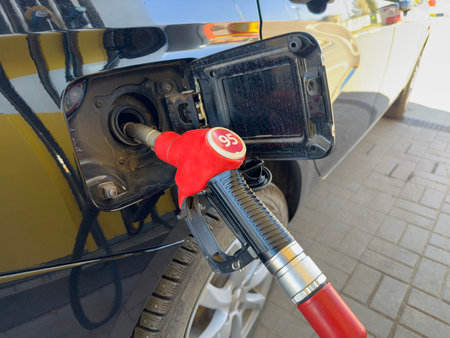 Filling gun with ninety-fifth gasoline in the carの写真素材