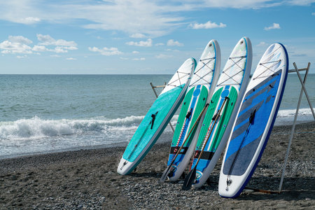 surfboards on the seashore against the blue sky