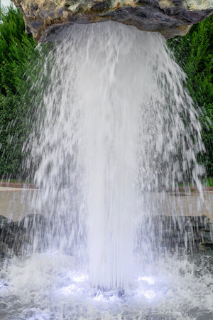 floating stone on the fountain jet with illuminationの写真素材