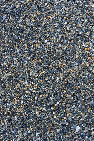 the texture of the pebbles in close-up as a backgroundの写真素材