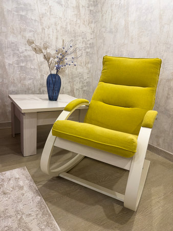 Modern Yellow Rocking Chair With Decorative Flowers in Stylish Interiorの写真素材