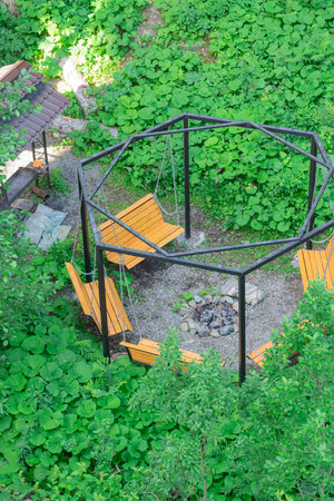 Relaxing Seating Area Surrounded by Lush Greenery and a Fire Pitの写真素材