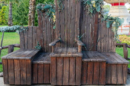 Decorative Wooden Bench With Natural Accents in a Lush Garden Settingの写真素材