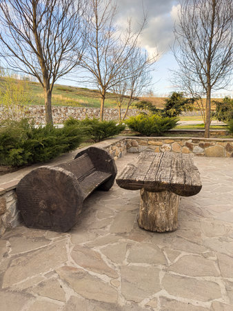 Rustic Wooden Seating and Table in a Serene Outdoor Areaの写真素材