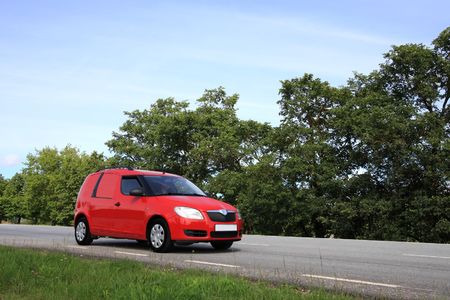 Red van on roadの写真素材