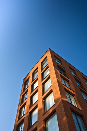 New office building with blue sky. Vertical background.