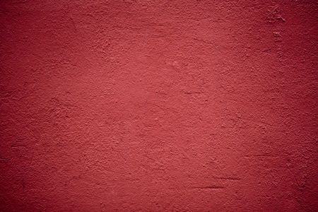 Red plaster wall backgroundの写真素材
