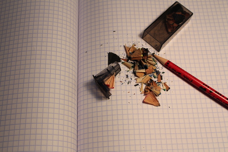 Pencil shavings on a tetrad sheet and a sharpenerの写真素材