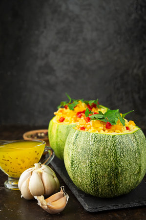 Stuffed zucchini with rice and vegetables on a dark table. side view. copyspace.の写真素材