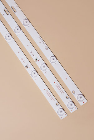 LED strips with lamps for LCD TV or monitor on a light background. Repair of TV, monitor. top view.