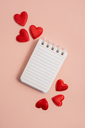 Notebook with hearts on a light background. Valentine concept, mother's day, birthday card. Flat lay, top view. copyspace.の写真素材