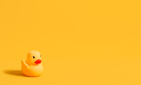 Rubber duck for swimming on a yellow background. Children's toy. Banner. copyspace.の写真素材