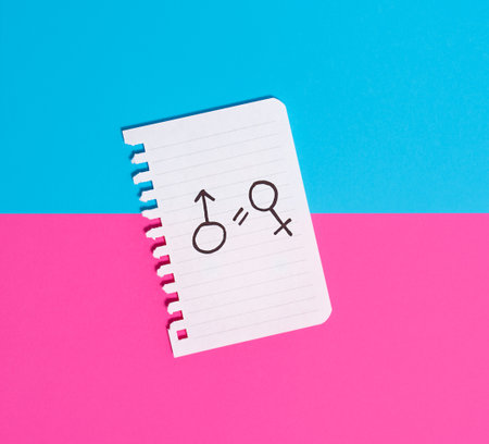 The concept of gender equality. Torn paper with painted female and male symbols on a blue-pink background. Equality of rights of men and women.の写真素材
