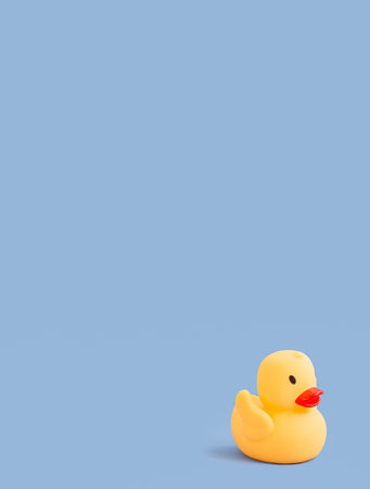 Rubber duck for swimming on a blue background. children's background. Children's toy. copyspace. Place for text.の写真素材