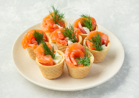 Snack with red fish on a plate on a light background. view from above. copyspace.の写真素材