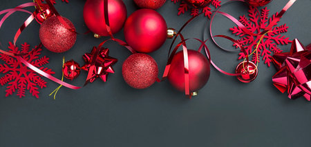 Christmas red balls and decorations on a dark background. New Year card. Christmas background. Copy...