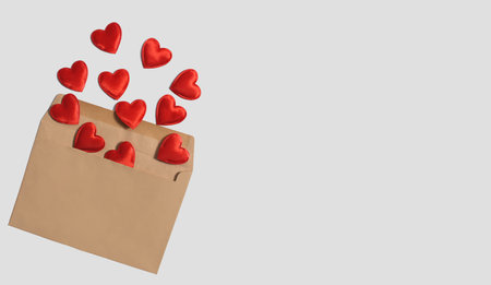 Kraft envelope with red hearts on a light background. Valentine concept. Correspondence concept....