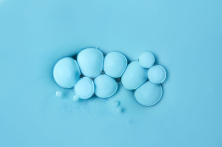 Blue floating bubbles on an oil basis. Acrylic paint. Abstract background.