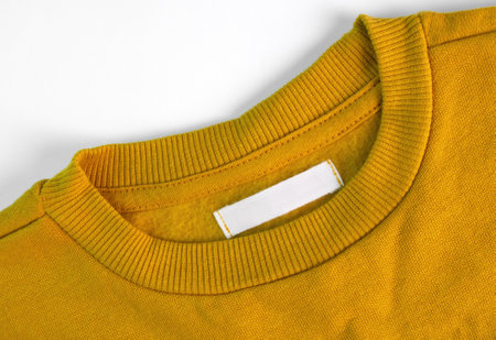 Blank clothing label on a yellow sweater. Textileの写真素材