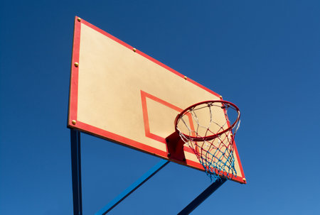 Basketball hoop against a clear blue sky on a sunny day. Basketball equipment. Side viewの写真素材