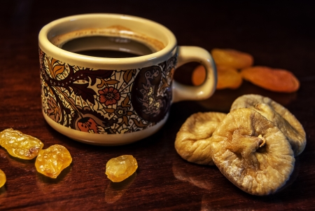 dried fruits and a cofee cup on a tableの写真素材