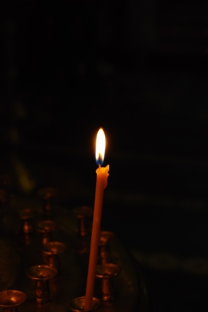 candle burns near icons in orthodox churchの写真素材