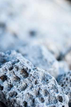 macro view of pumice on stony beach near seaの写真素材