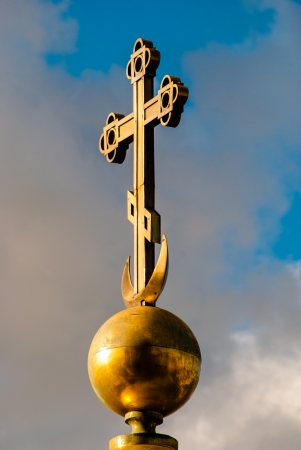 christian cross against blue cloudy skiesの写真素材