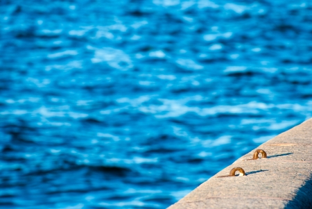 Flowing water surface near granite quayの写真素材