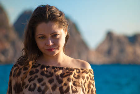 girl staring against rocks and seaの写真素材