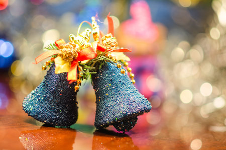 christmas bells near decorated tree