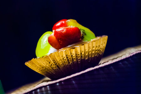 cupcakes with berries on wooden mat