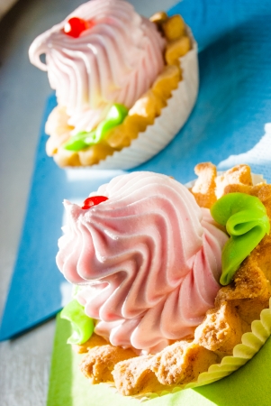 colored cupcakes on napkins in morning sunlight near window, macroの写真素材