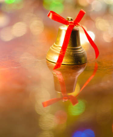 christmas bell near decorated treeの写真素材