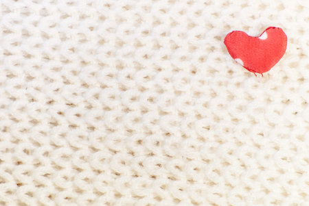 heart of red textile on woven fabric