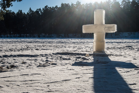 ice christian cross on frozen lakeの写真素材