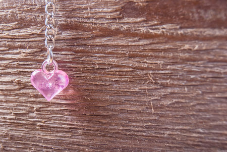 pink plastic heart on wood