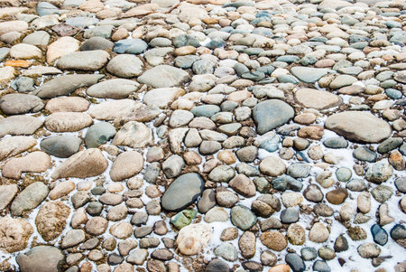 stones with snow, river bank in winter