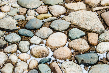 stones with snow, river bank in winter