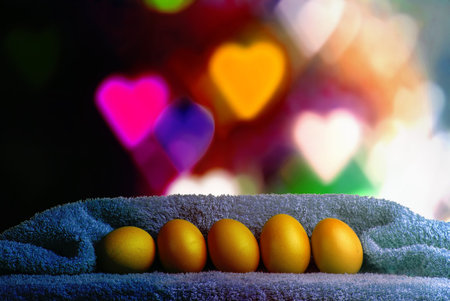 Easter decoration. Background with eggs and Turkish towel on defocused background with hearts